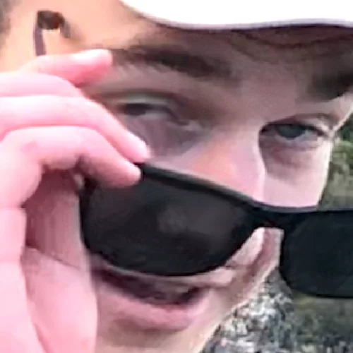 Randy lifting his sunglasses